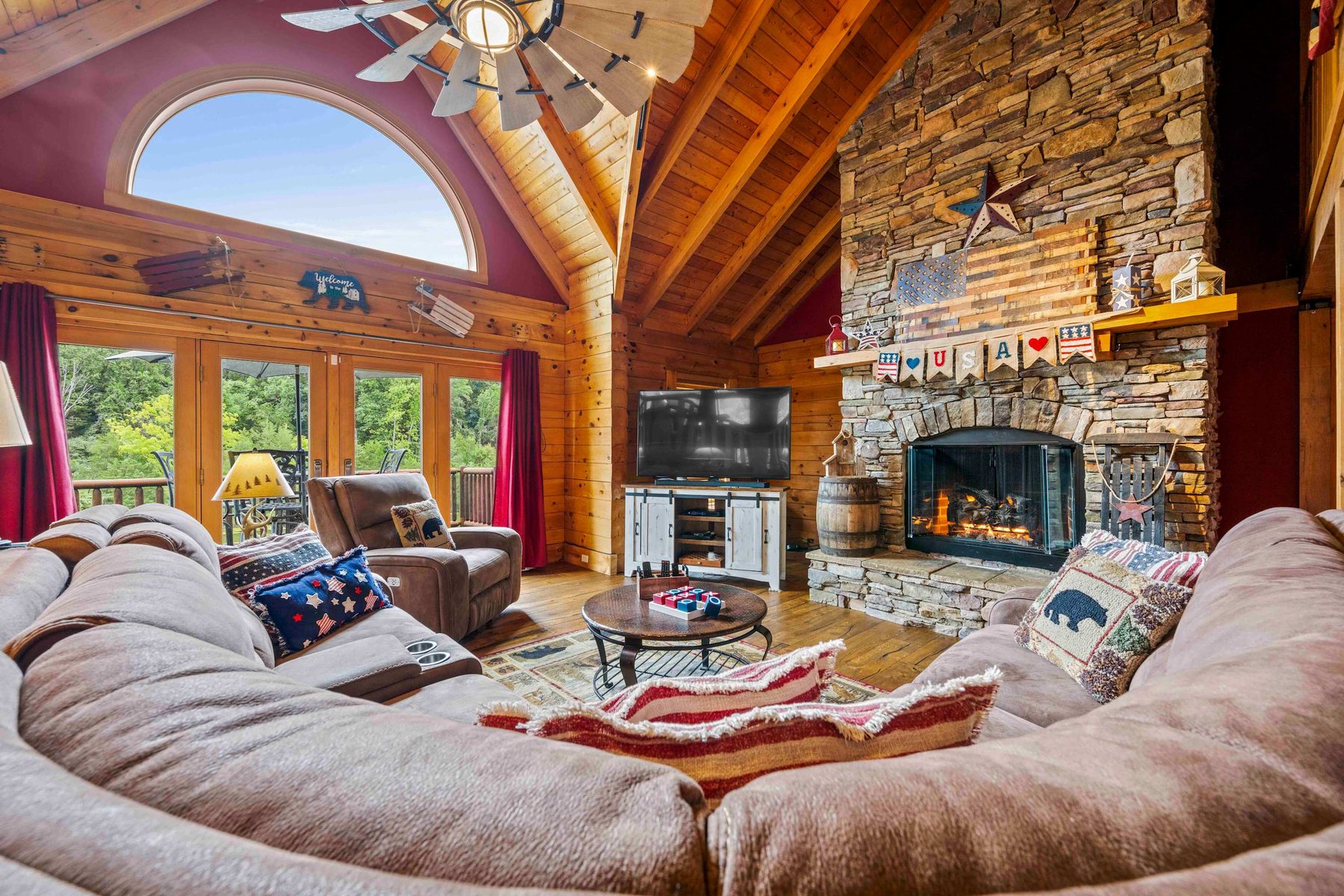 Warm cabin living room with a stone fireplace